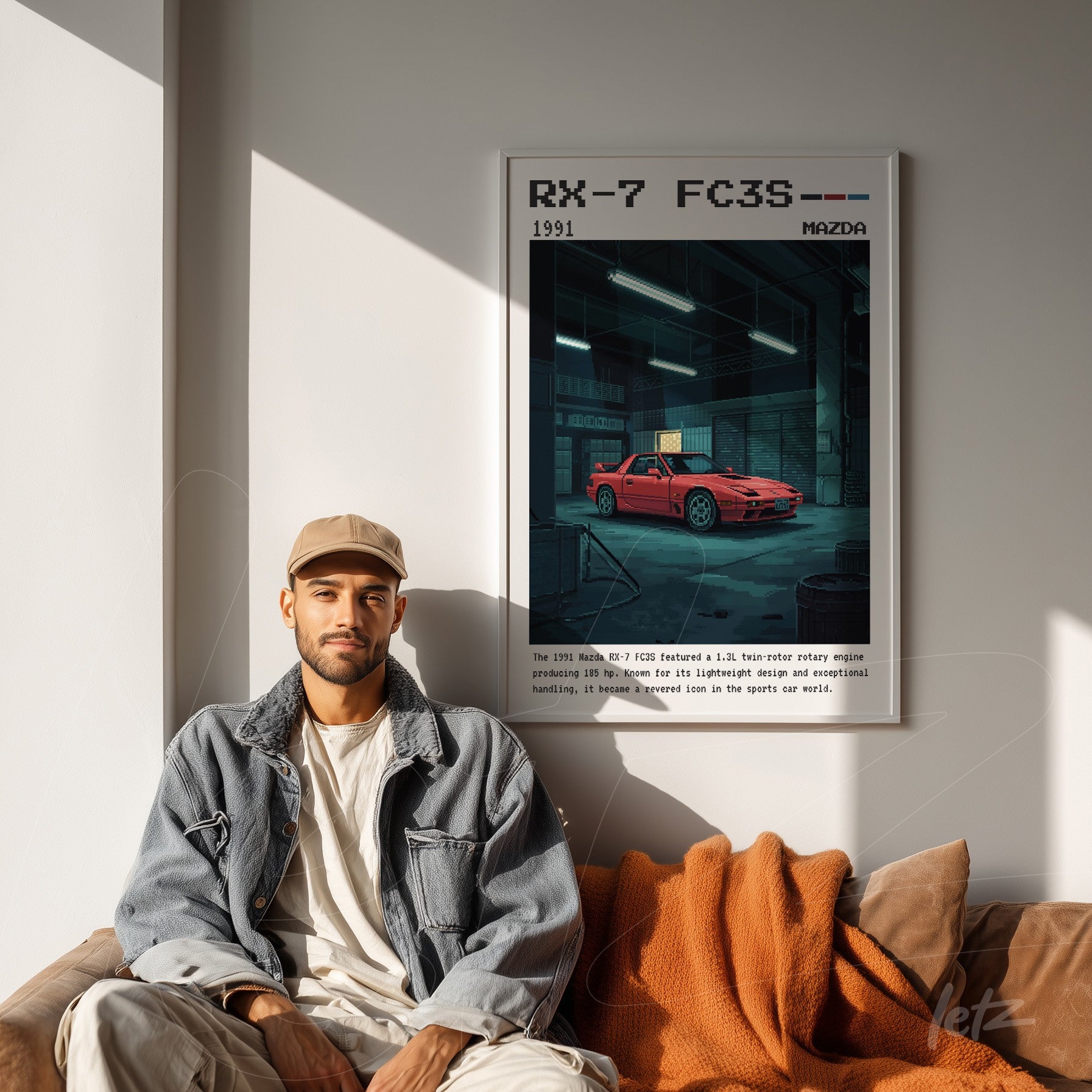 framed wall art featuring an illustration of the Mazda RX-7 FC3S above a sofa with an orange blanket