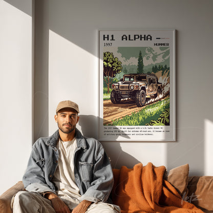 framed pixel art of Hummer H1 Alpha on light wall with a man sitting next to it on a cushioned sofa