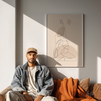 minimalist line art depicting a seated human figure, framed on a white wall behind a sofa with a man and orange blanket