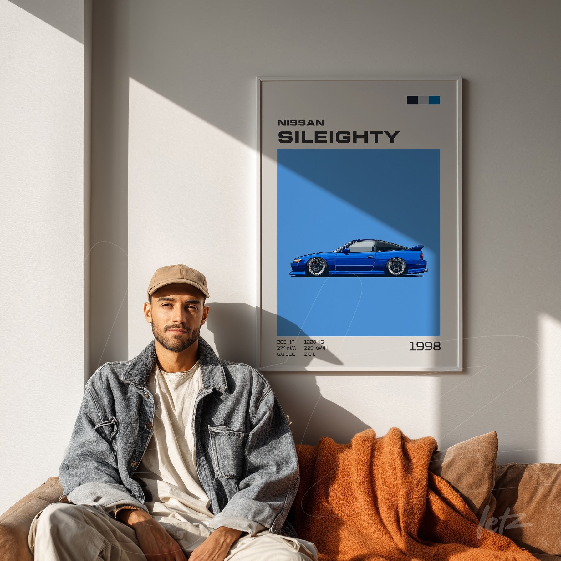 framed digital art of Nissan Sil80 car on a light wall next to a man sitting on a sofa