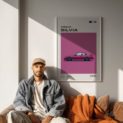 decorative wall art featuring a pink illustration of the Nissan Silvia in a white frame, displayed in a modern setting with a brown sofa and orange blanket