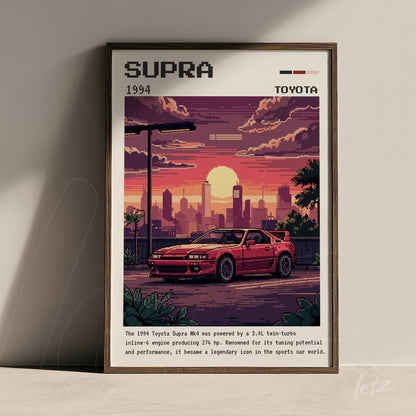 framed pixel art featuring a red Toyota Supra against an urban skyline at sunset