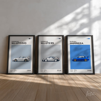 collection of framed wall art featuring sports cars, including porsche 911 gt2 evo from 1993, 911 gt2 rs from 2018, and subaru impreza from 1998, all with black frames and neutral background