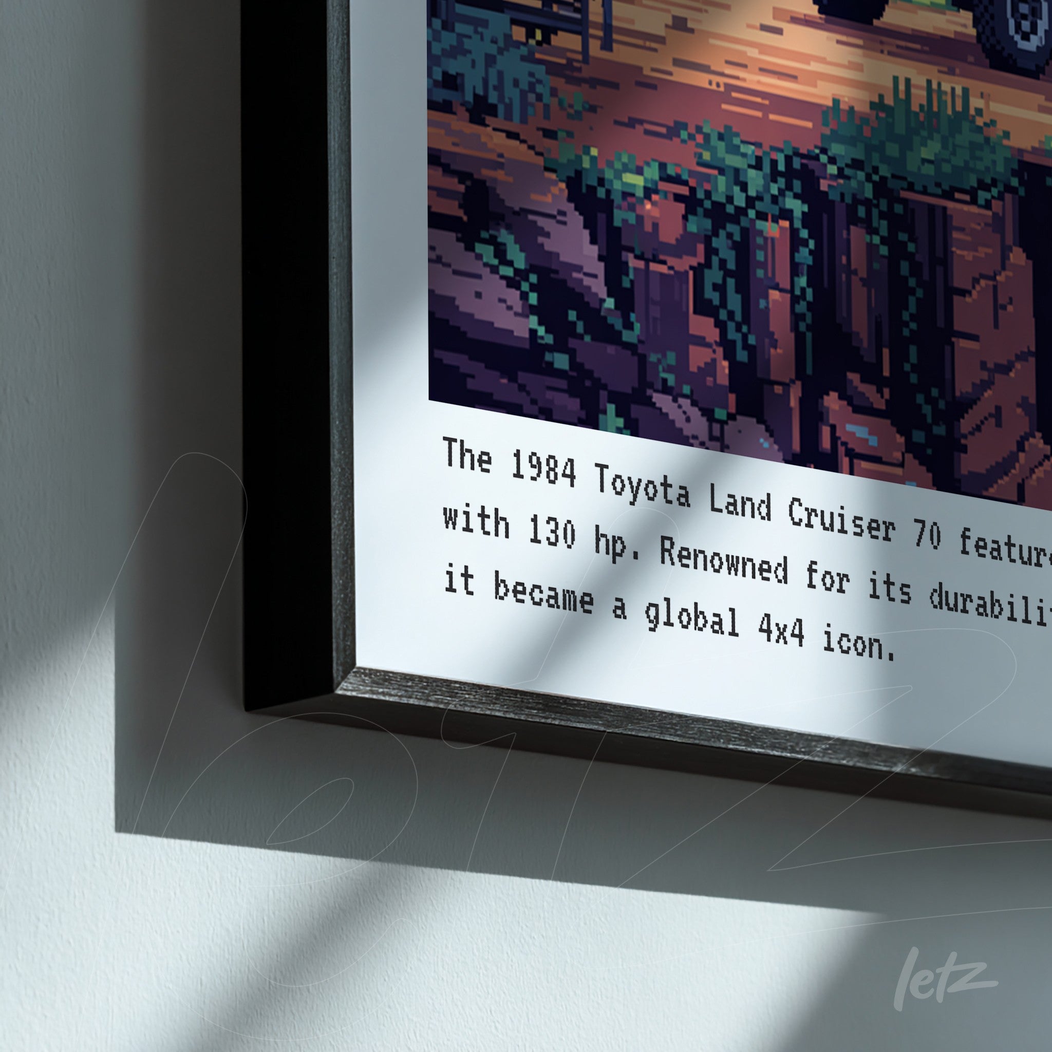 pixel art framed print of a 1984 toyota land cruiser 70 in an off-road scene with sleek black frame and informative text below the image
