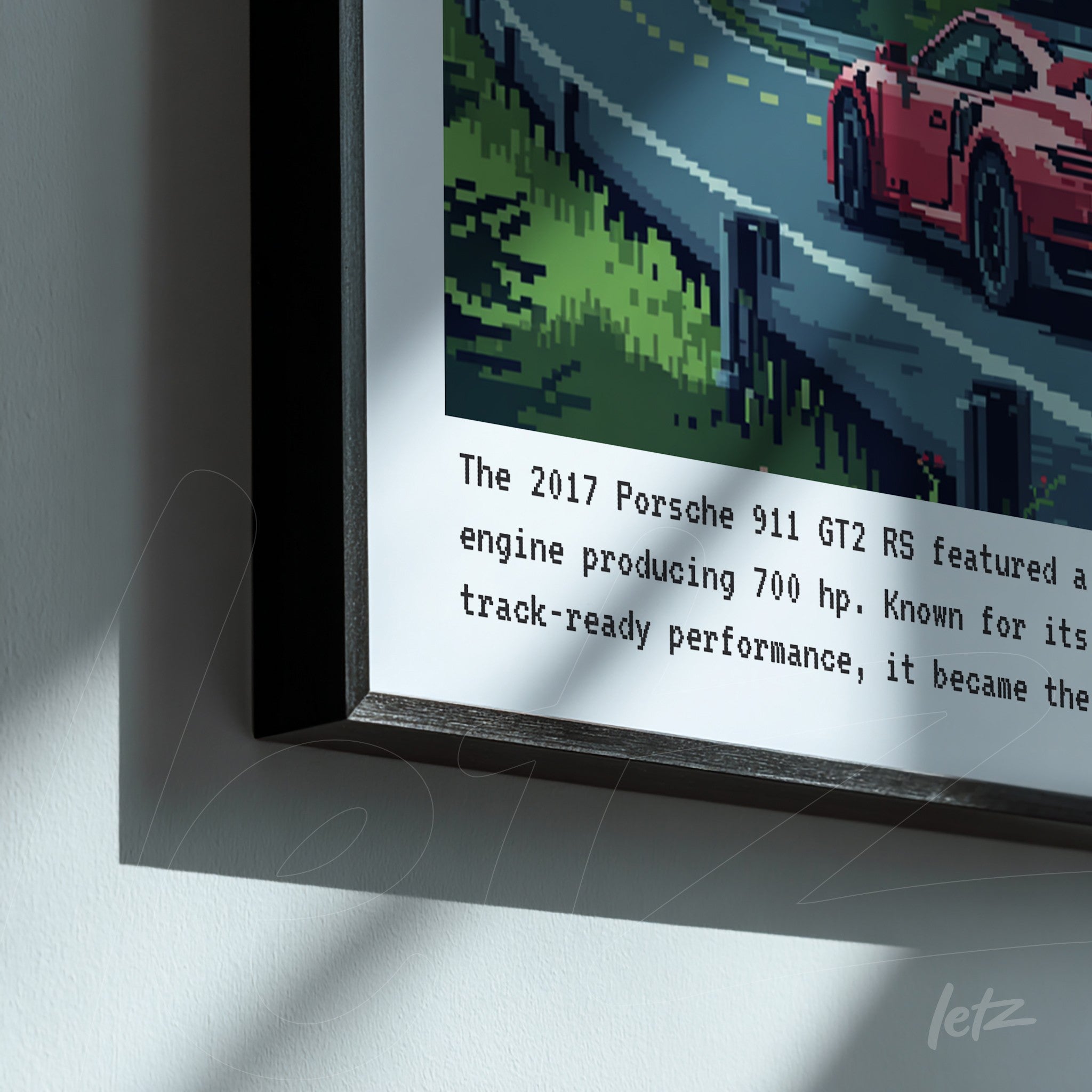 framed pixel art of a 2017 Porsche 911 GT2 RS on a winding road with a black frame and informational text below