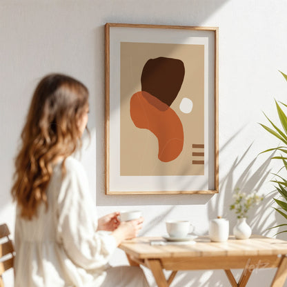 abstract art in earthy tones with organic shapes and wooden frame in a coffee setting