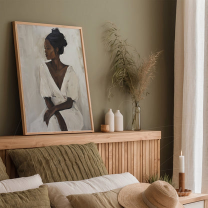 framed modern art portrait of a thoughtful woman displayed in a cozy setting with green walls