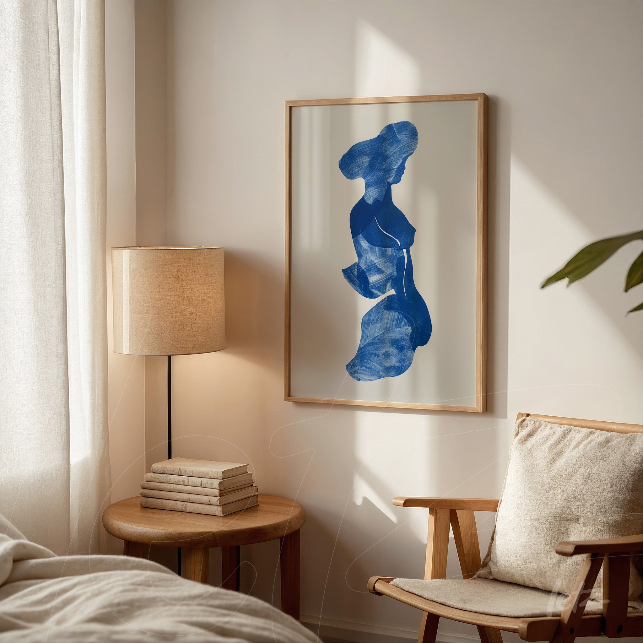 abstract wall art featuring a female figure in blue tones framed in light wood displayed on a bedroom wall