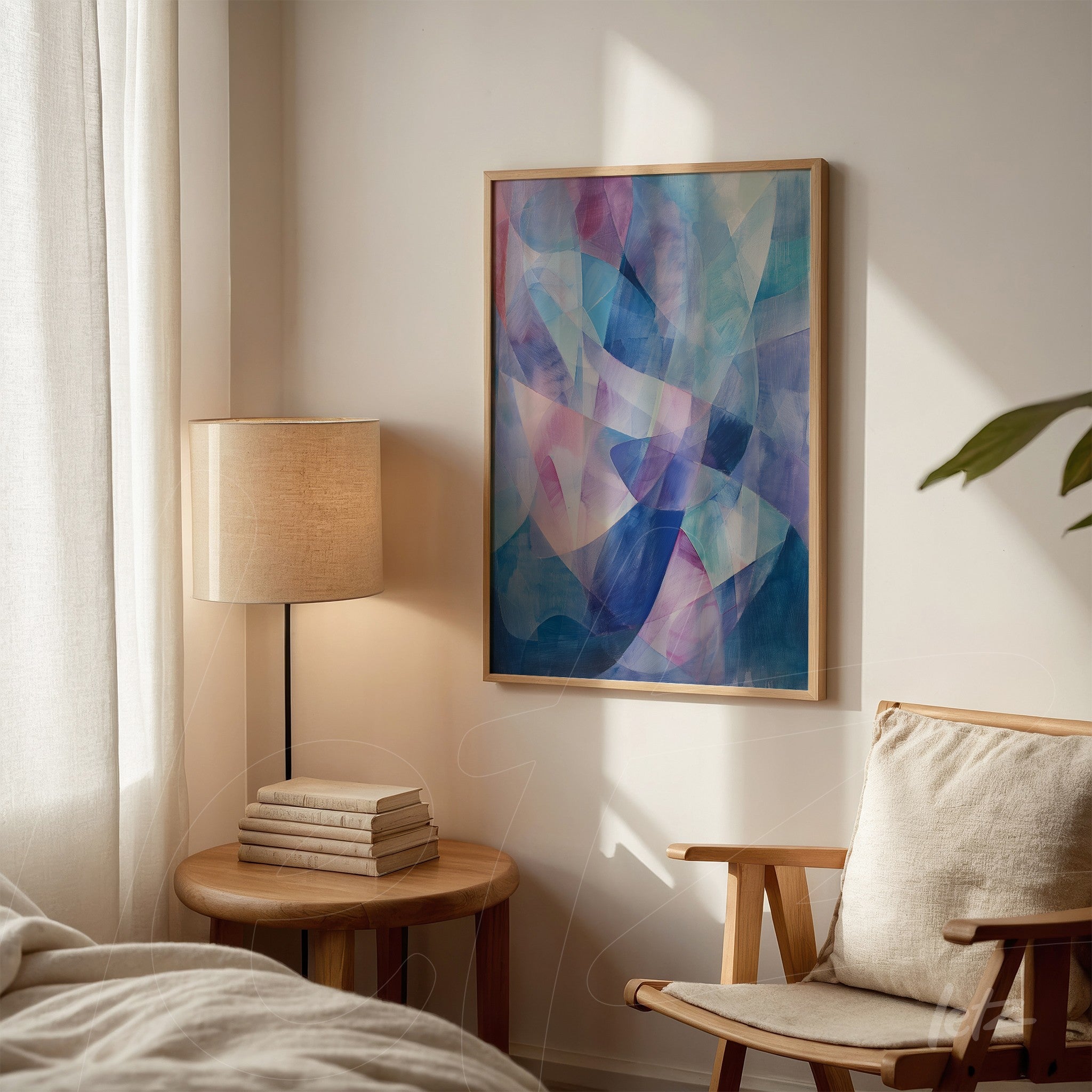 framed abstract art in shades of blue and pink displayed on light wall with soft lighting