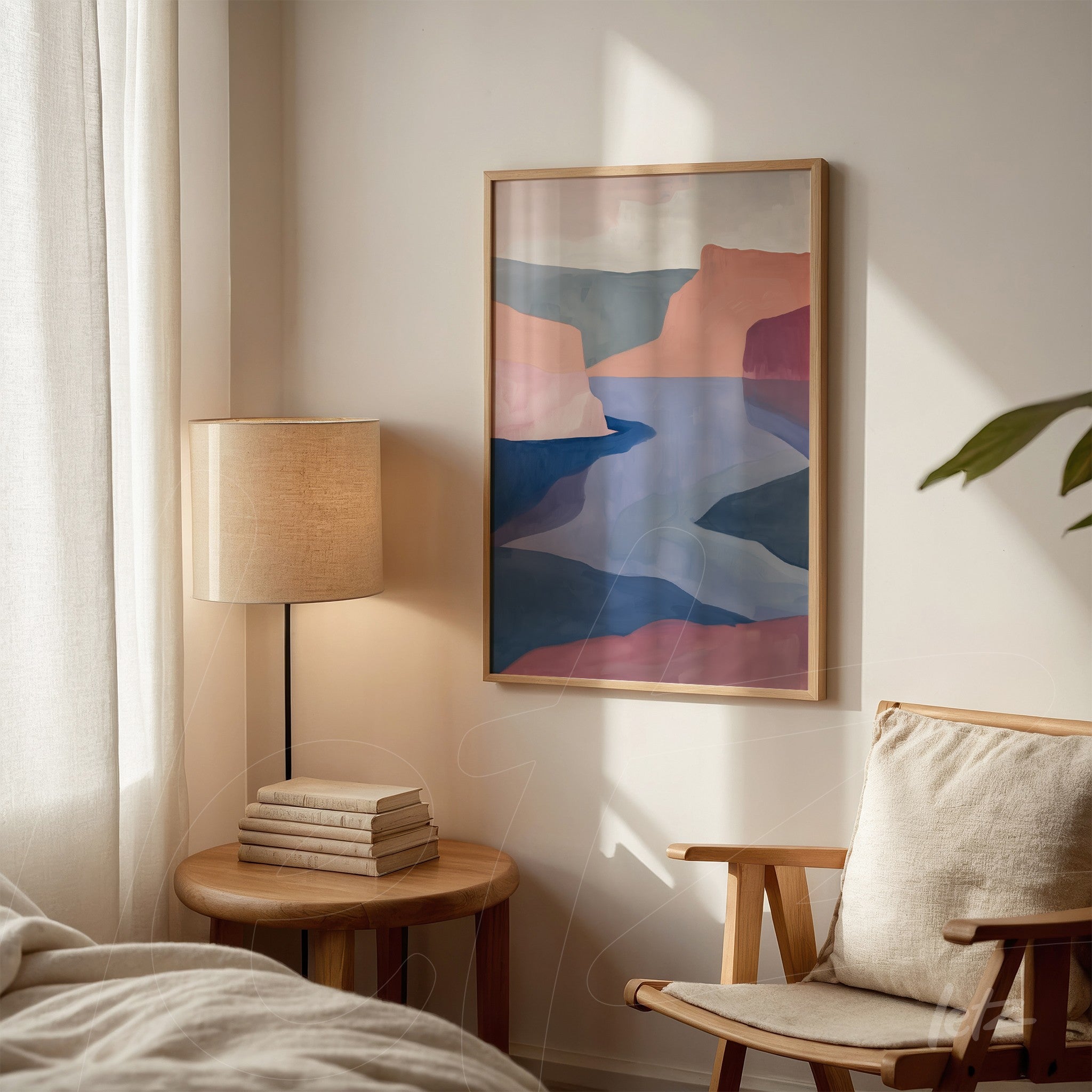 abstract landscape wall art in shades of pink, blue, and terracotta framed in light wood displayed in a bright bedroom setting