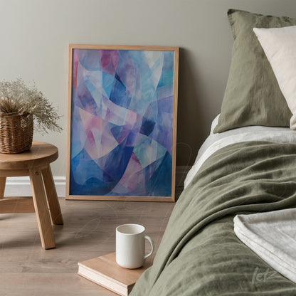 abstract framed wall art with shades of blue and pink leaning next to a bed in a modern bedroom