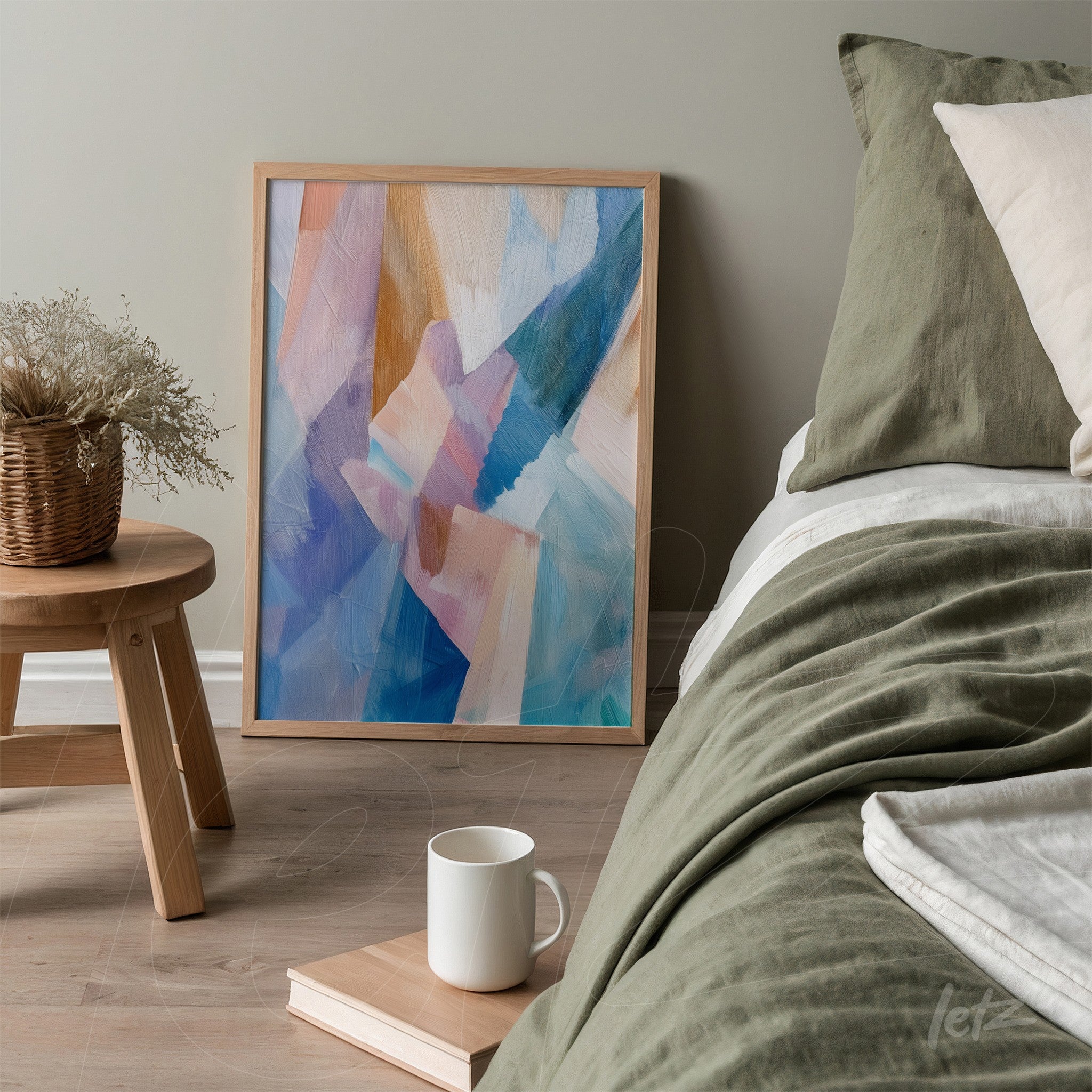 framed abstract wall art in light wood displayed beside a bed with neutral bedding