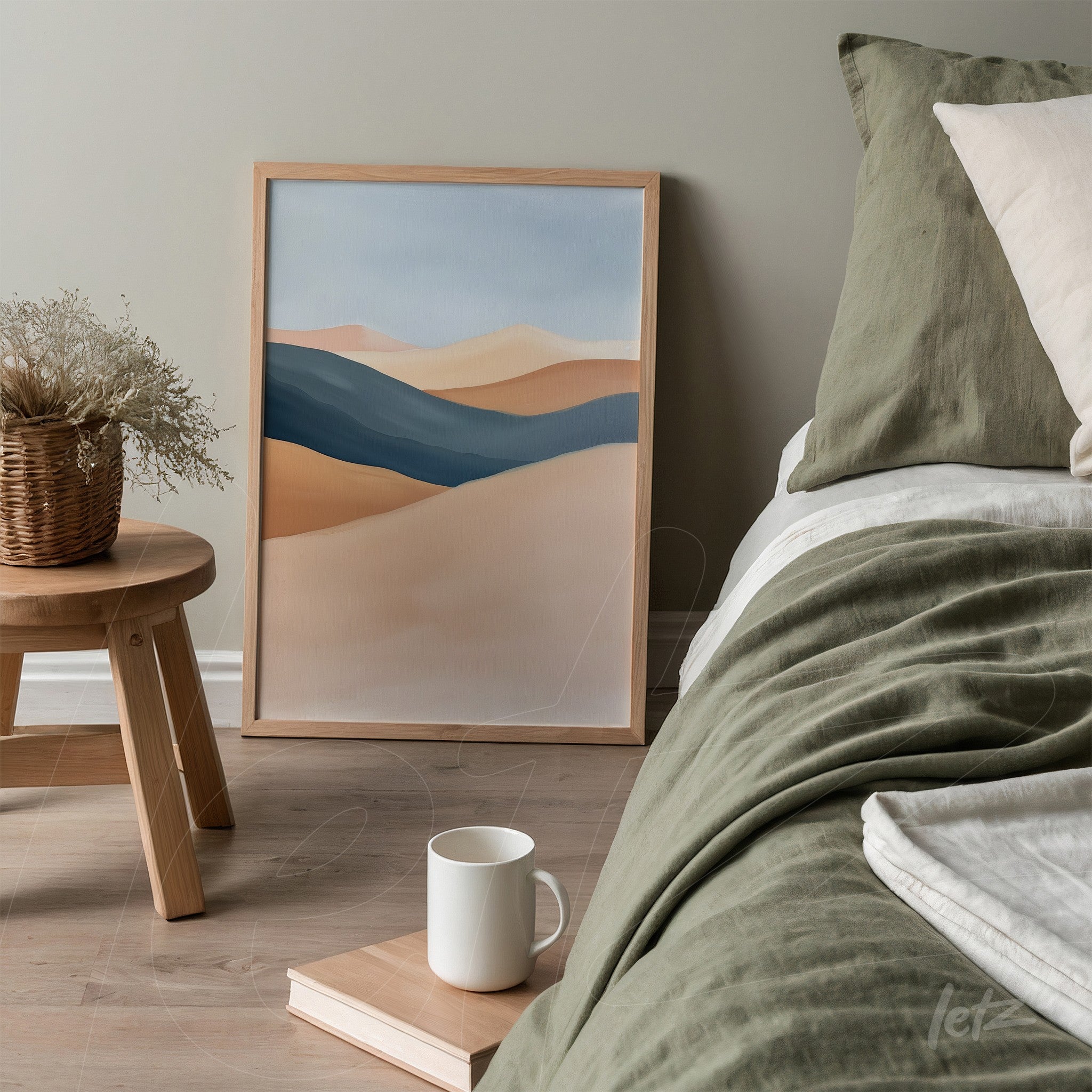 framed abstract landscape art in light wood displayed on a wooden table beside a bed