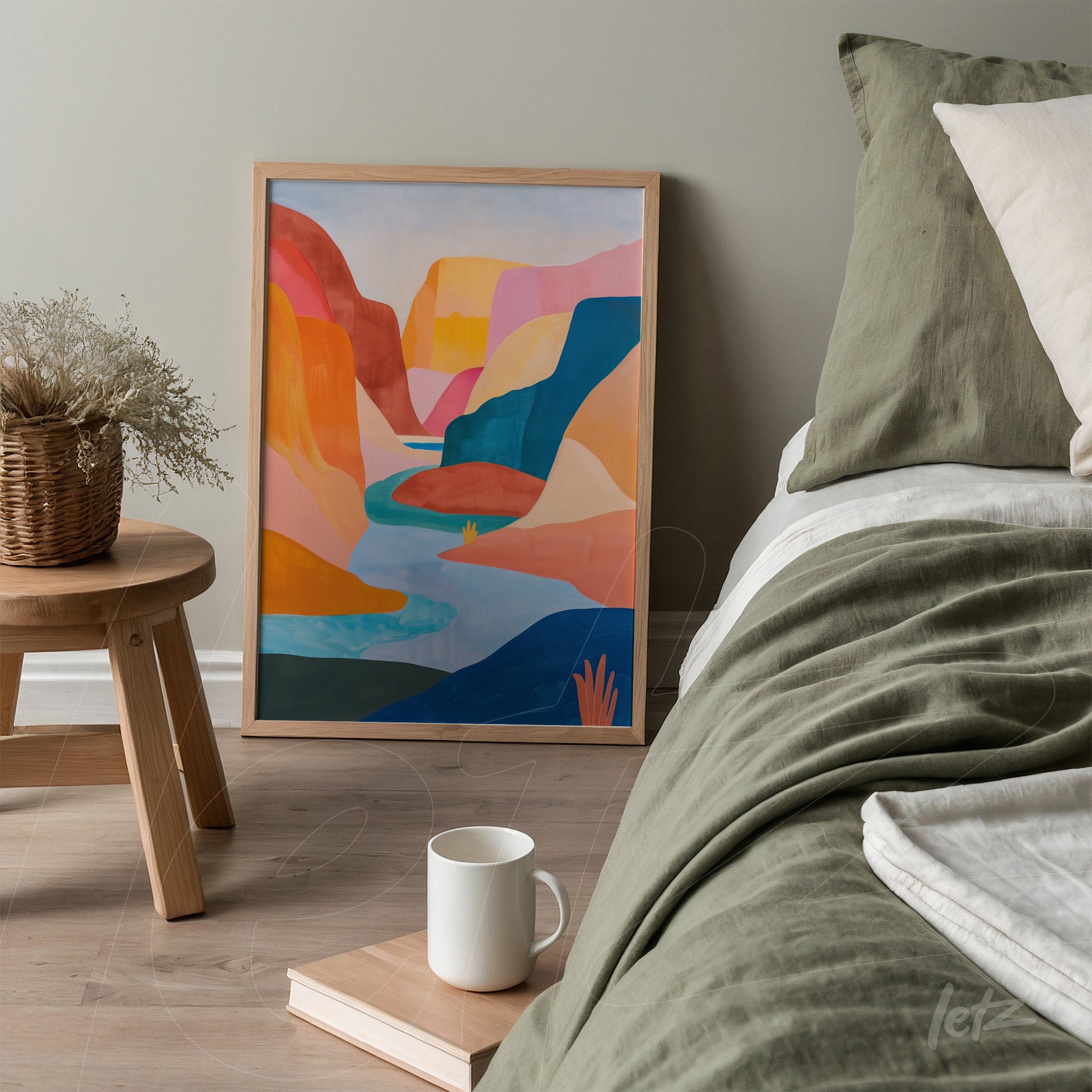 colorful abstract landscape painting in a light wooden frame displayed next to a bed with neutral toned bedding