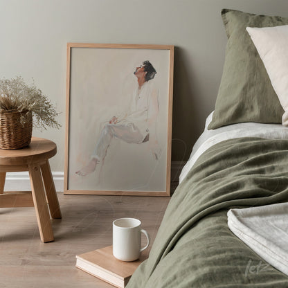 framed minimalist illustration of a human figure in light wood frame leaning next to the bed in a cozy environment