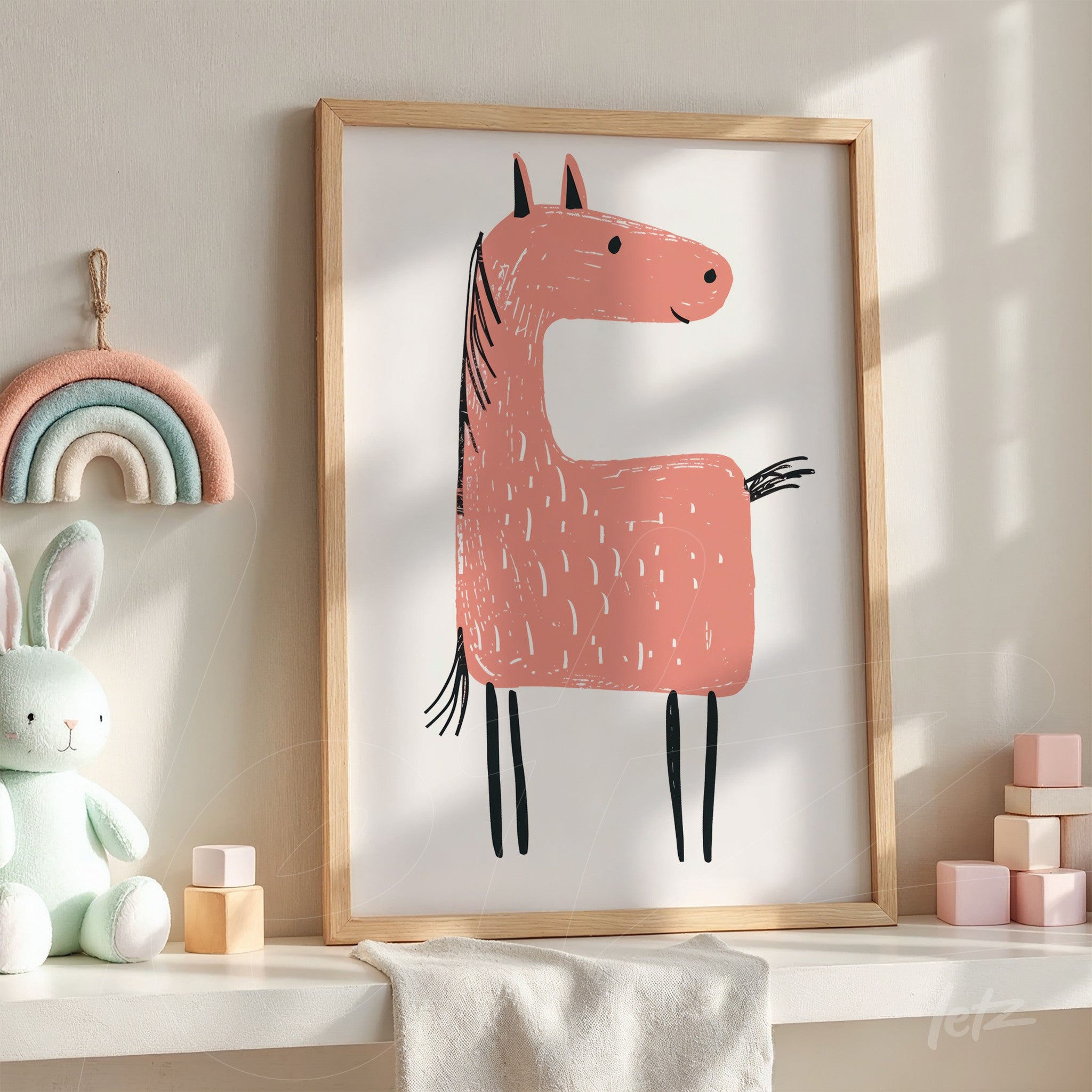 framed artwork featuring a pink horse illustration in a light wood frame displayed in a naturally lit setting