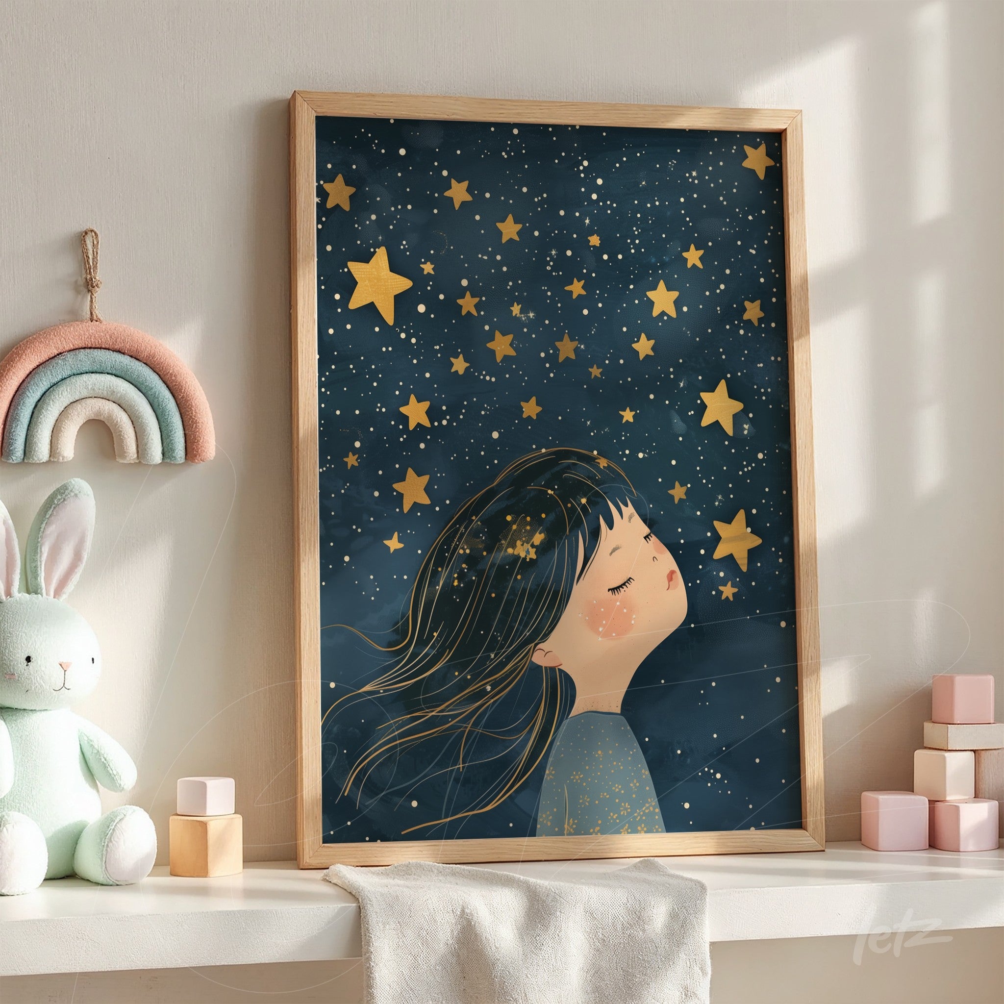 framed artwork of a girl dreaming under a starry sky with light wooden frame and deep blue background
