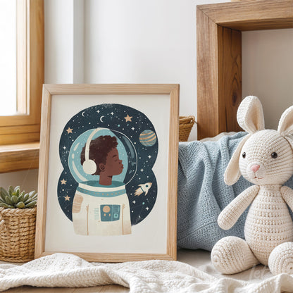 framed art of a child astronaut against a starry background with a light wooden frame displayed on a table with toys