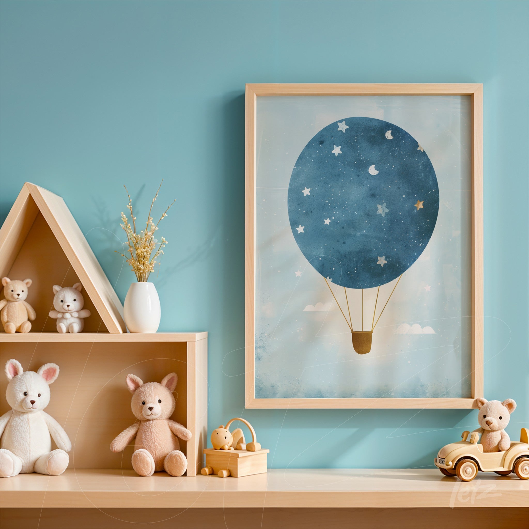 framed art print featuring a blue hot air balloon illustrated with stars and clouds set against a soft blue background, displayed on a shelf alongside plush toy animals