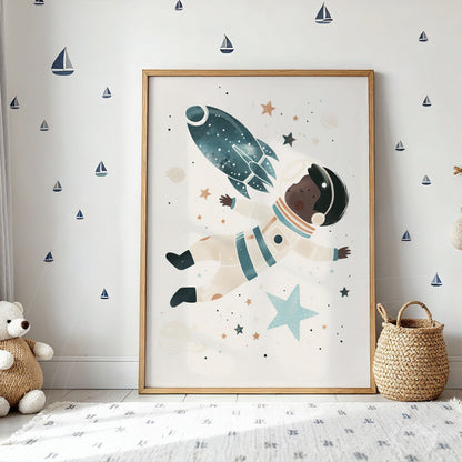 framed wall art featuring a playful illustration of a child astronaut floating among stars with a light wood frame