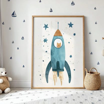 framed children’s illustration of a blue rocket against a light background with light wood frame