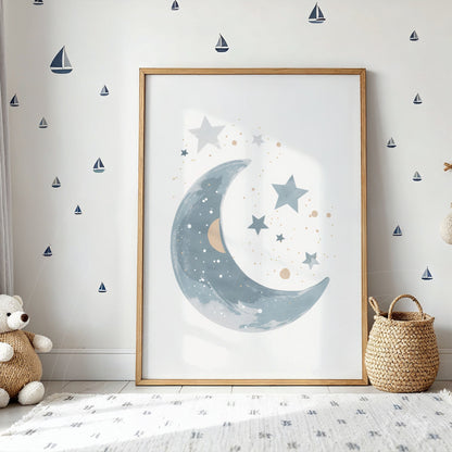 framed art featuring a moon and stars in light wood frame against a white wall