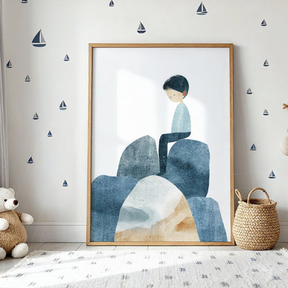 framed artwork featuring a boy sitting on rocks with a soft blue color palette and gentle details