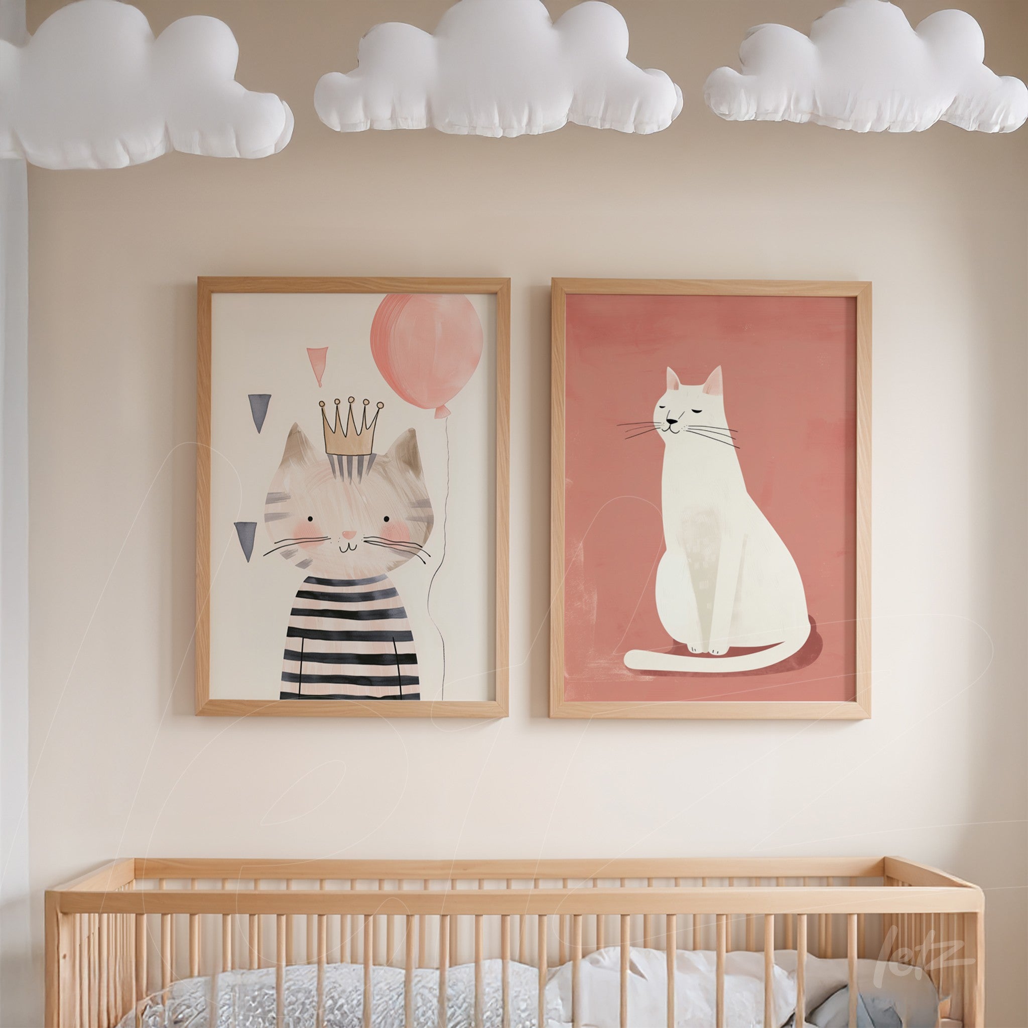 set of framed artworks featuring cat illustrations in light wood frames, one showing a striped cat wearing a crown with a balloon, and another featuring a white cat on a pink background