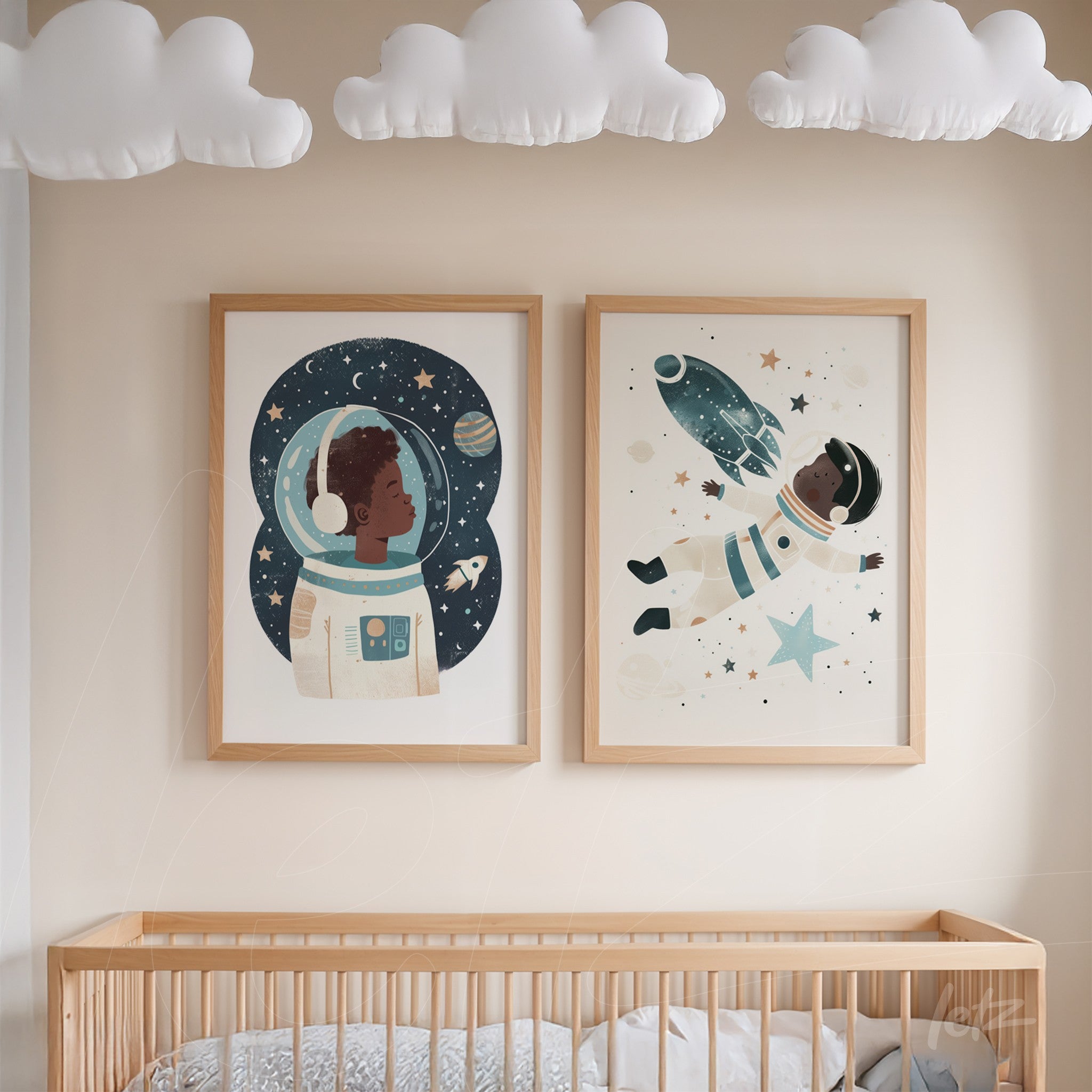 framed artwork composition featuring astronaut illustrations with light wood frames displayed above a crib in a children's room
