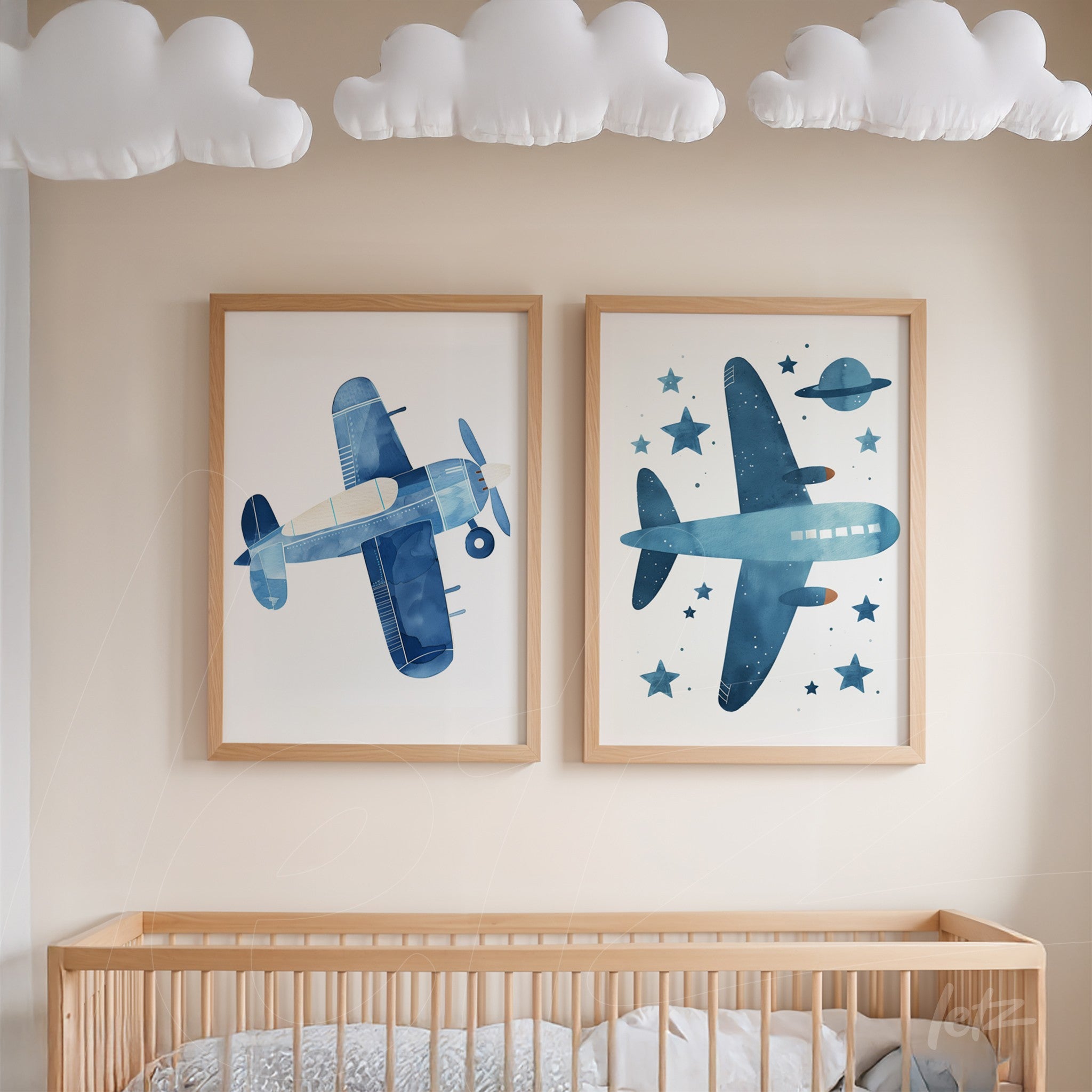 set of two framed artworks with light wood frames, featuring a blue airplane on one side and a blue airplane with planets against a white background on the other side