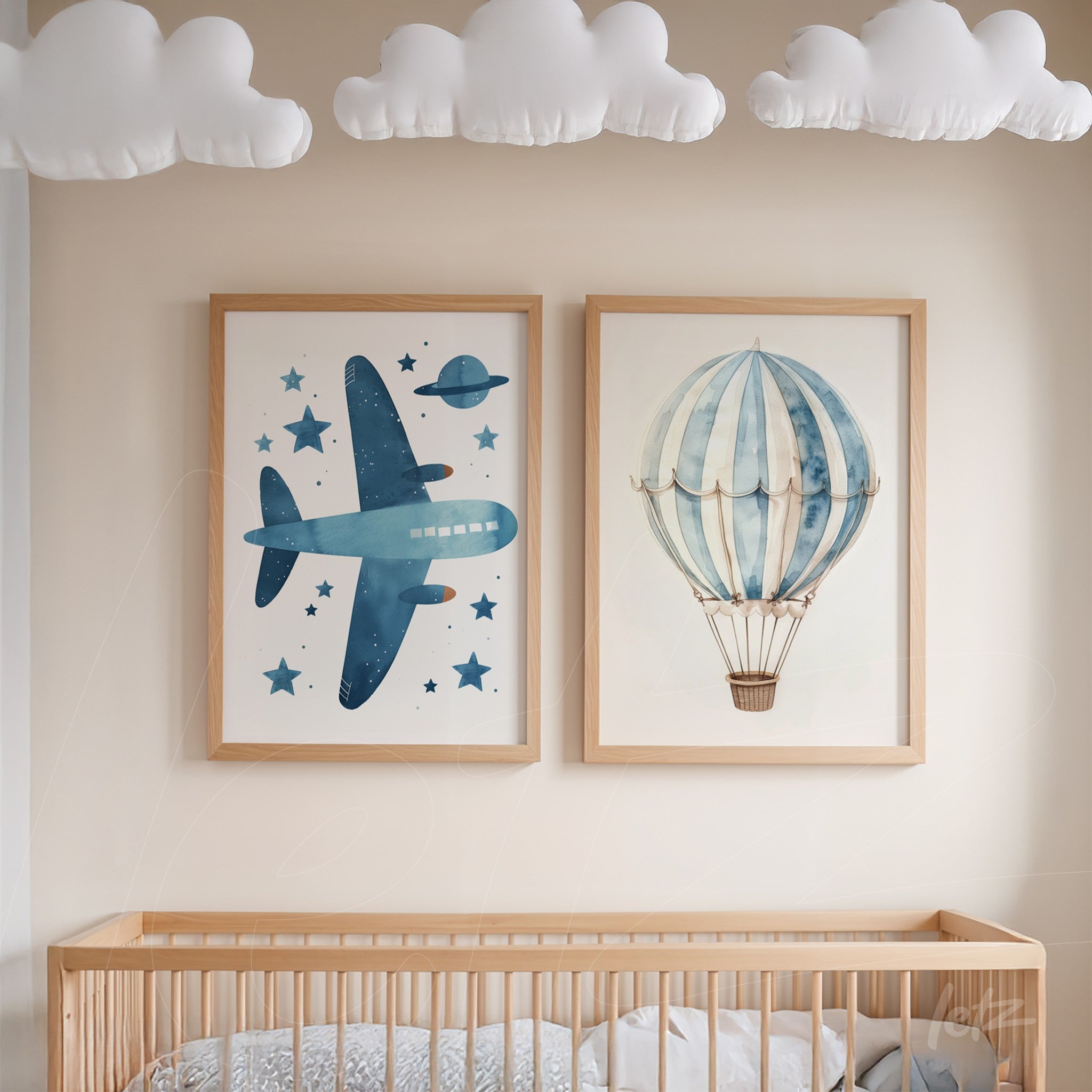 decorative wall art composition featuring illustrations of a blue airplane and a hot air balloon in light wood frames, displayed above a crib in a children's room