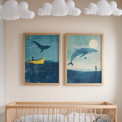 framed illustrations of whales against a navy blue background with light wood frame displayed above a crib in a nursery
