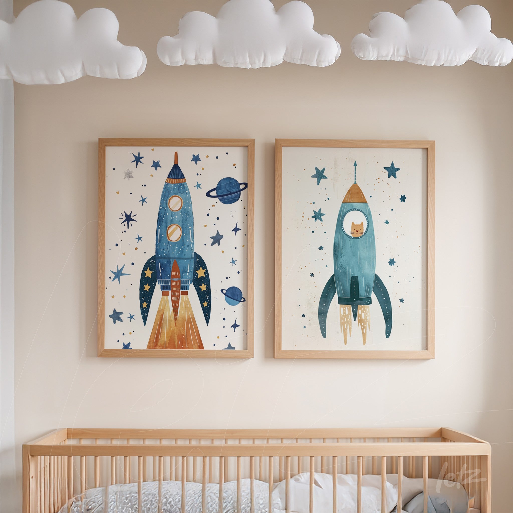 composition of two framed space-themed artworks, one featuring a blue rocket and the other a green rocket, both in light wood frames, hung on a neutral wall next to a crib