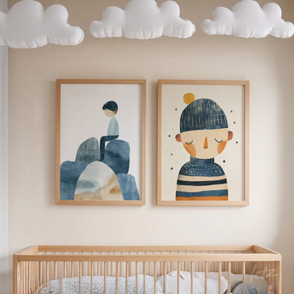 composition of children's wall art featuring illustrations in blue tones, one boy sitting on rocks and another wearing a hat in light wood frame