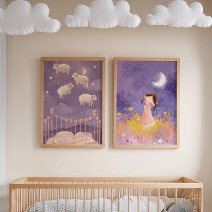 set of two children's framed artworks featuring soft illustrations, one with floating sheep in a starry sky and the other with a girl in a pink dress, displayed in light wood frames on a beige wall