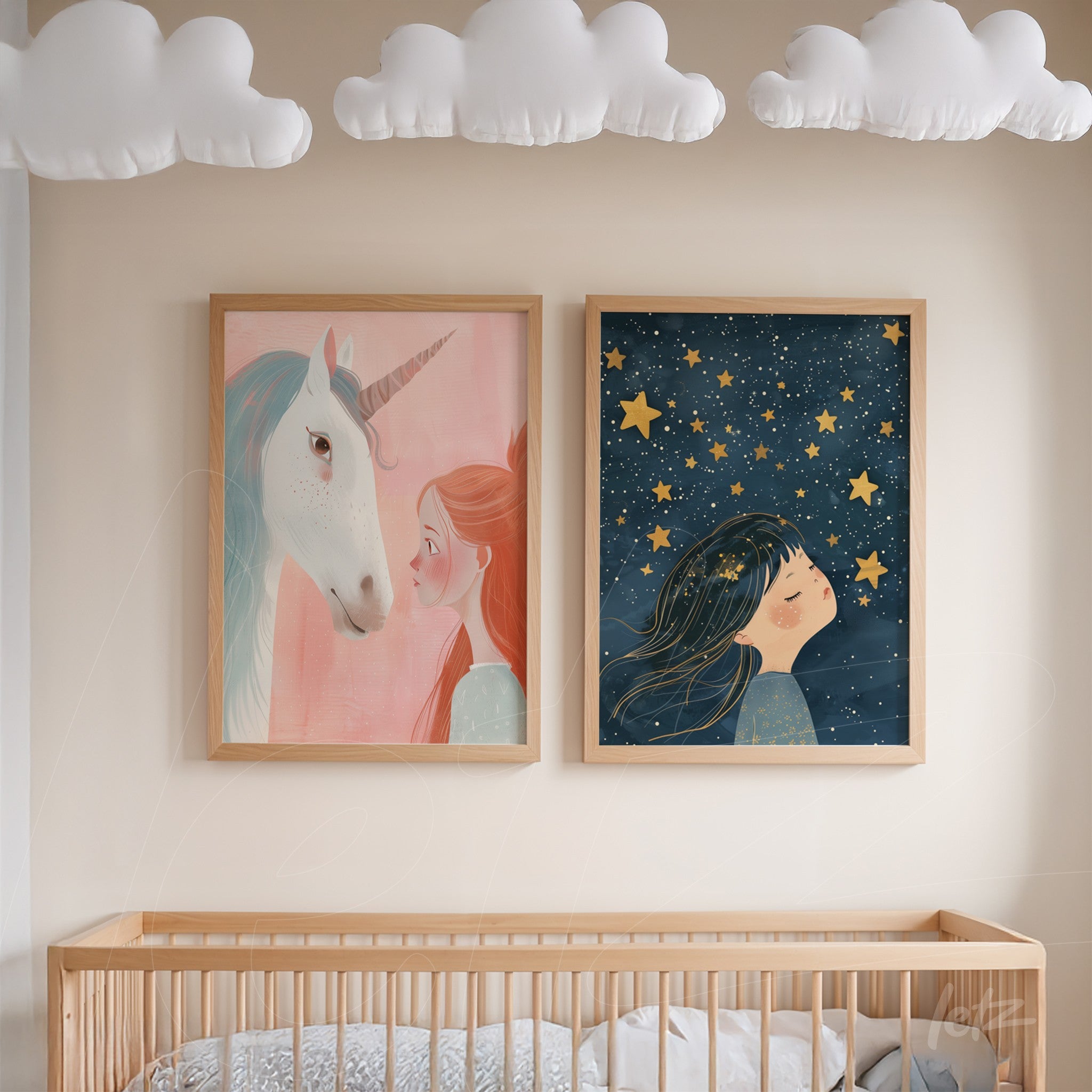 pair of decorative prints featuring whimsical illustrations, one depicting a girl with a unicorn against a pink background and the other showing a girl gazing at stars on a dark blue backdrop, both in light wood frames
