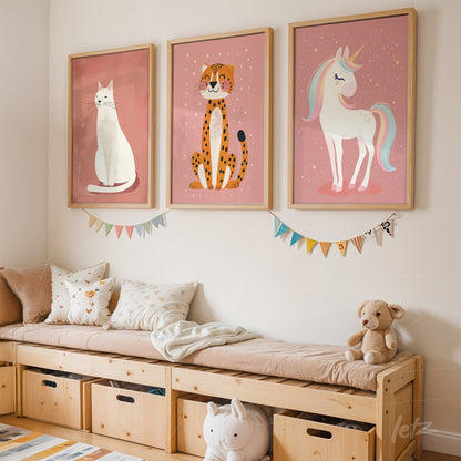 series of framed wall art featuring cute illustrations of a white cat, a spotted leopard, and a unicorn on a pink wall