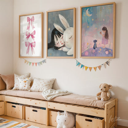 series of framed children's illustrations in light wood frames featuring a girl with a bunny and a girl with pink bows