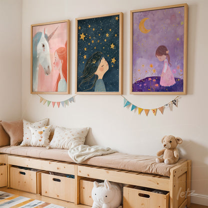 collection of framed wall art featuring child illustrations, including a unicorn, a girl with stars, and a girl under the moon, displayed on a light wall next to a wooden bench