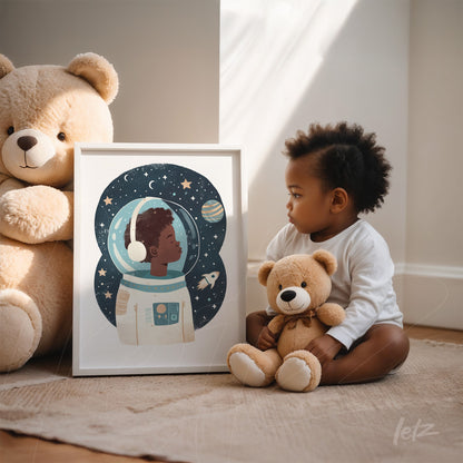 framed artwork of a child astronaut in a cosmic background next to a boy holding a teddy bear