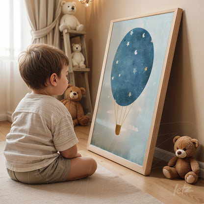 framed art featuring a blue hot air balloon with stars on a light background displayed in a light wood frame, with a child sitting in front in a cozy setting