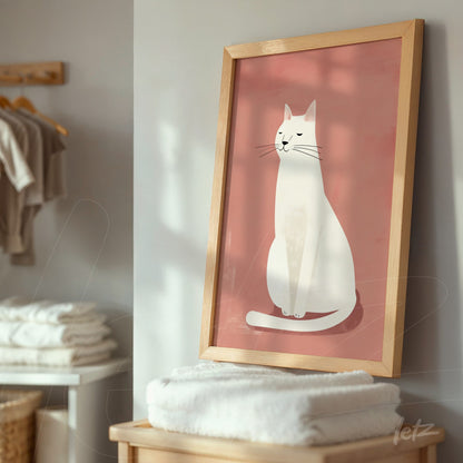 framed minimalistic illustration of a white cat on a pink background with a light wood frame displayed on a furniture piece in a home setting