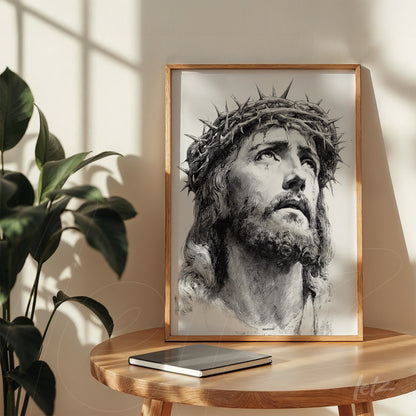 framed black and white art of Jesus' face with a crown of thorns in a light wood frame
