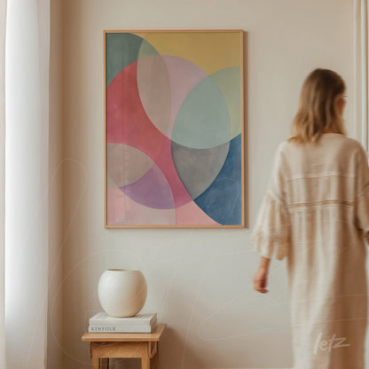 framed abstract artwork in pastel colors featuring geometric shapes displayed on a light wall