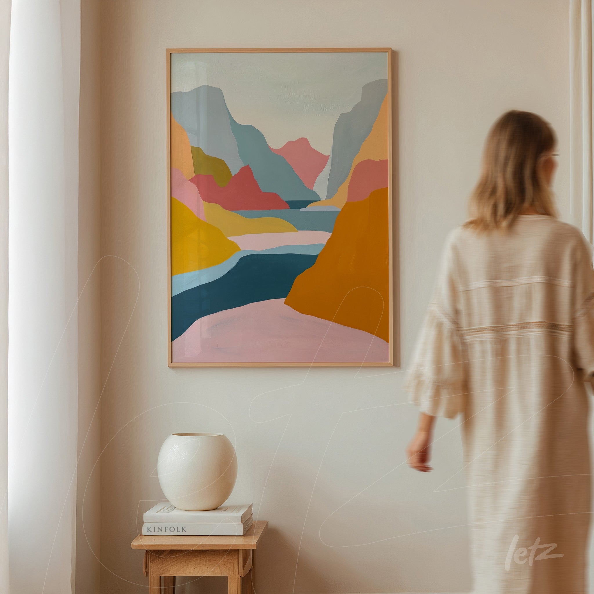framed wall art featuring an abstract landscape with colorful mountains and a serene lake in shades of pink, yellow, and blue