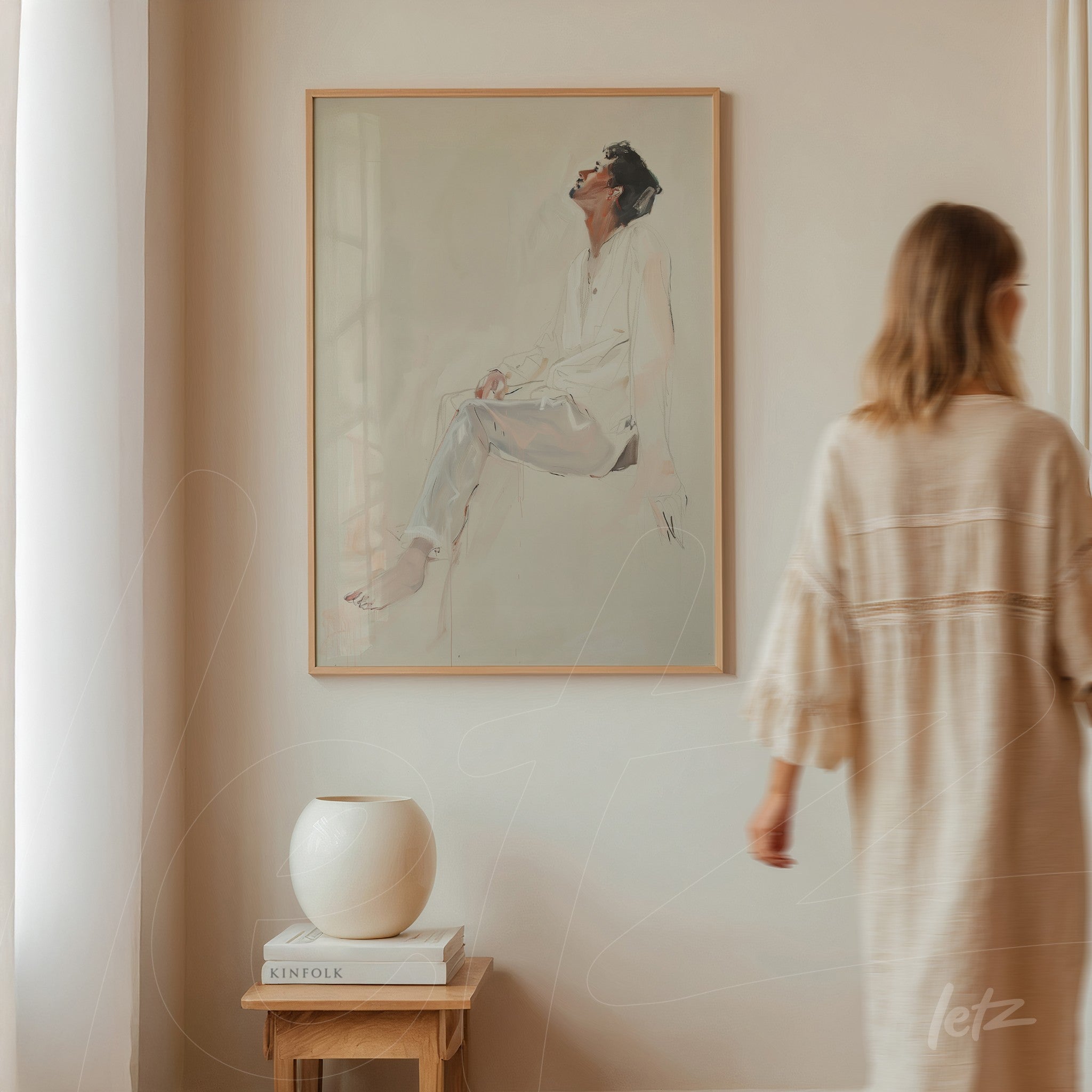 minimalist style wall art featuring a portrait of a seated woman in light frame displayed on a neutral wall