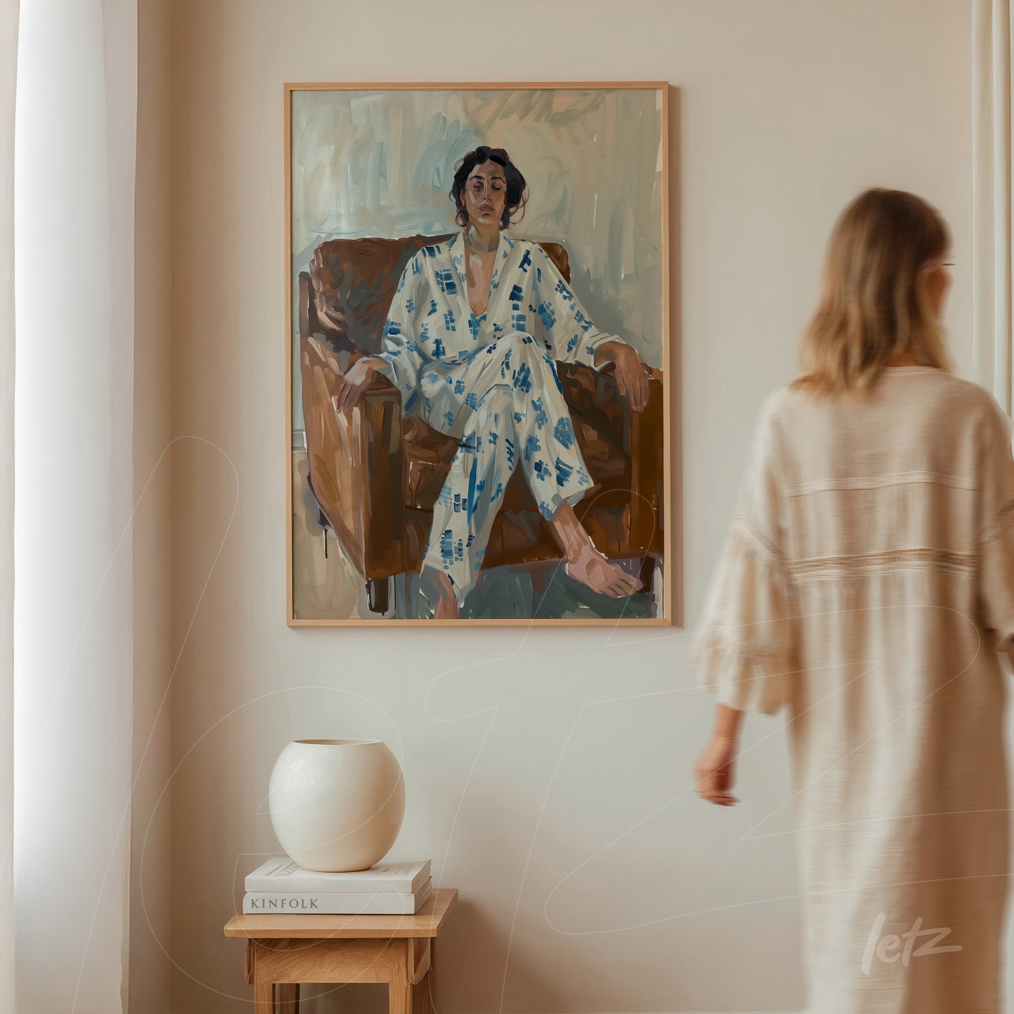 framed portrait of a woman sitting on a sofa, wearing a floral robe with light wood frame