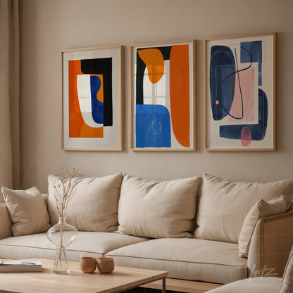 set of three framed abstract art pieces in light frames displayed above a neutral sofa in a modern living space