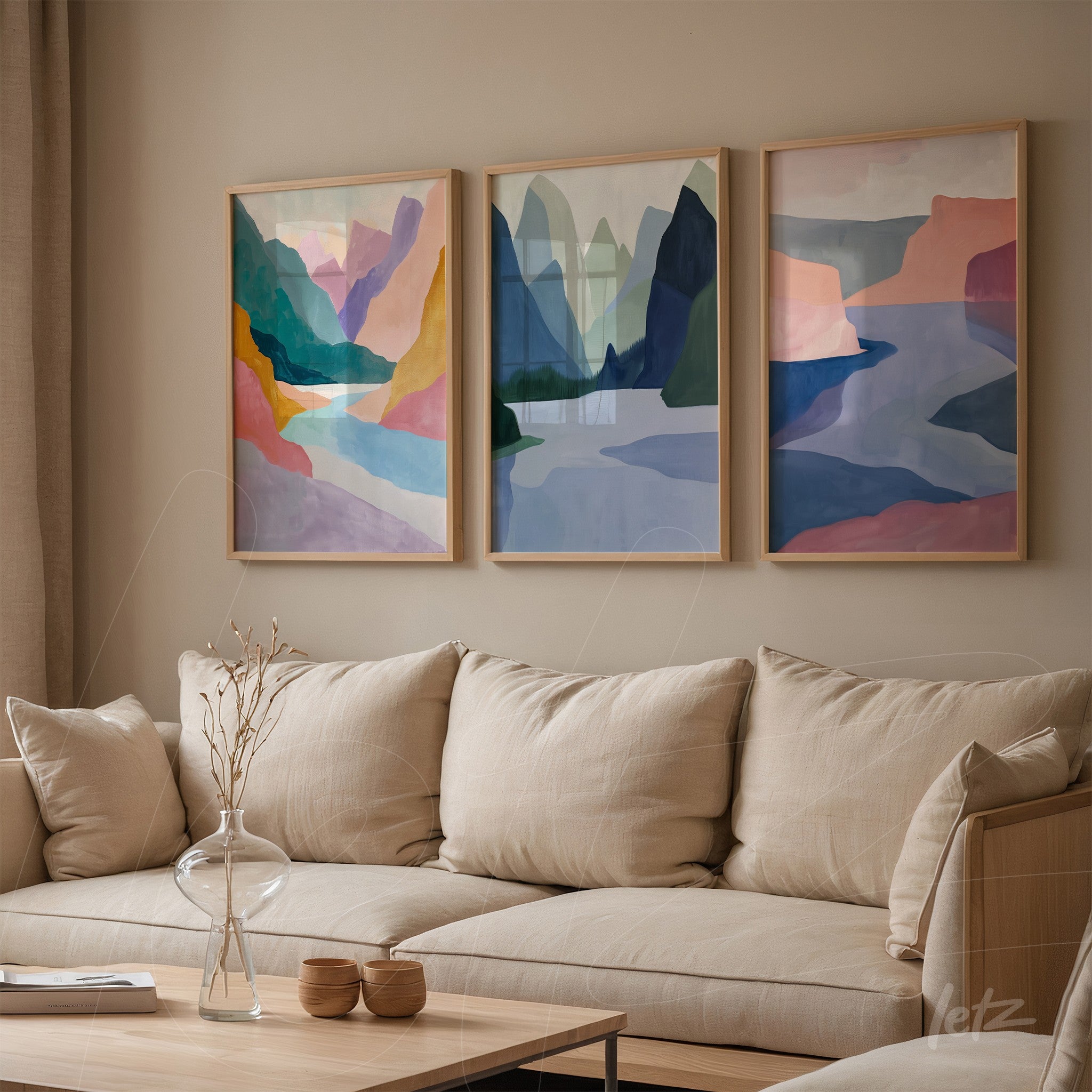 set of three abstract art framed pieces showcasing mountains and geometric shapes in soft shades of blue, pink, and green on a neutral wall