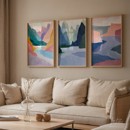 set of three abstract art framed pieces showcasing mountains and geometric shapes in soft shades of blue, pink, and green on a neutral wall